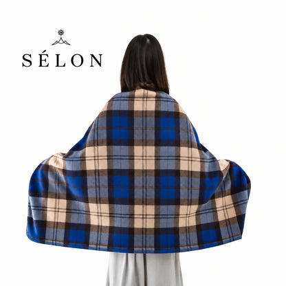 Back view of the flannel shawl in navy and tan plaid, arms outstretched