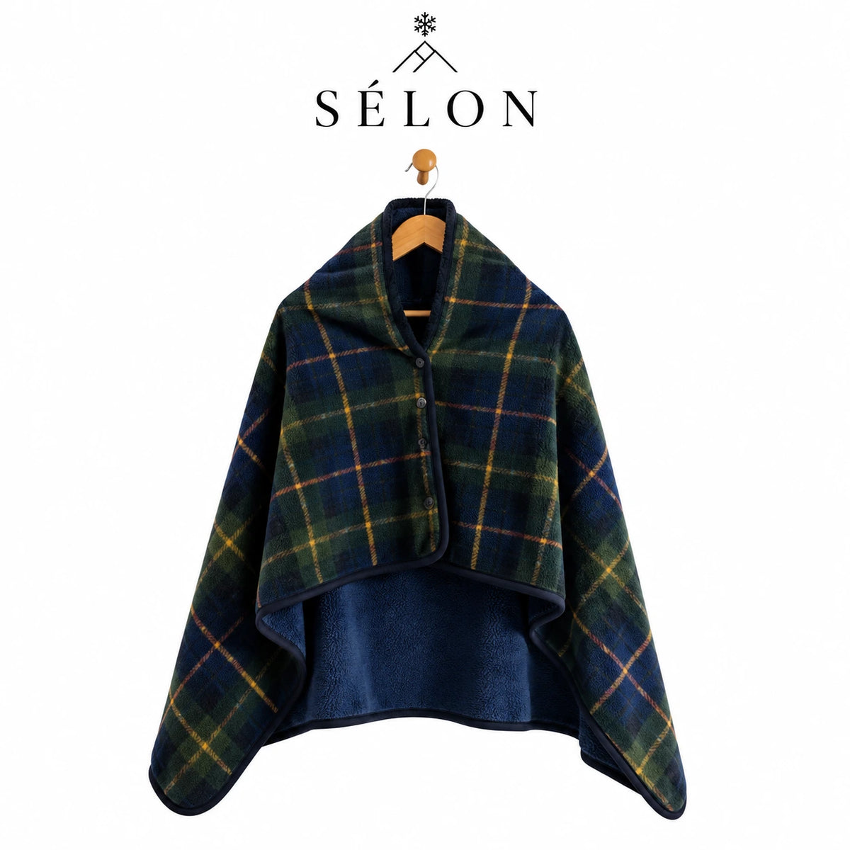 Green and navy tartan flannel shawl hanging on a wooden hanger